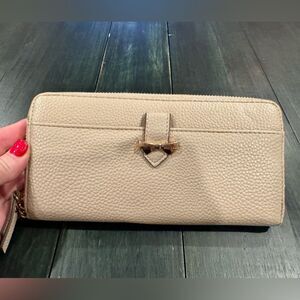 Anne Klein beige pebbled faux leather zip-around wallet gold-tone bow accent
